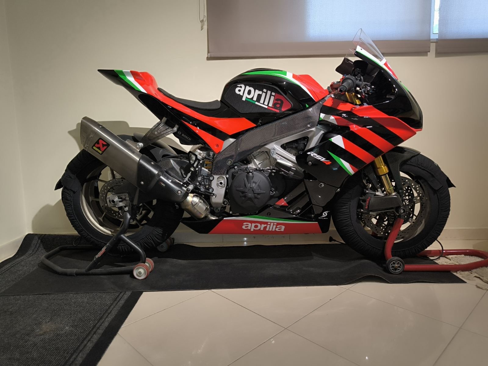 Full side profile of the Aprilia RSV4 showing the aprilia wordmark along the tail and fairing