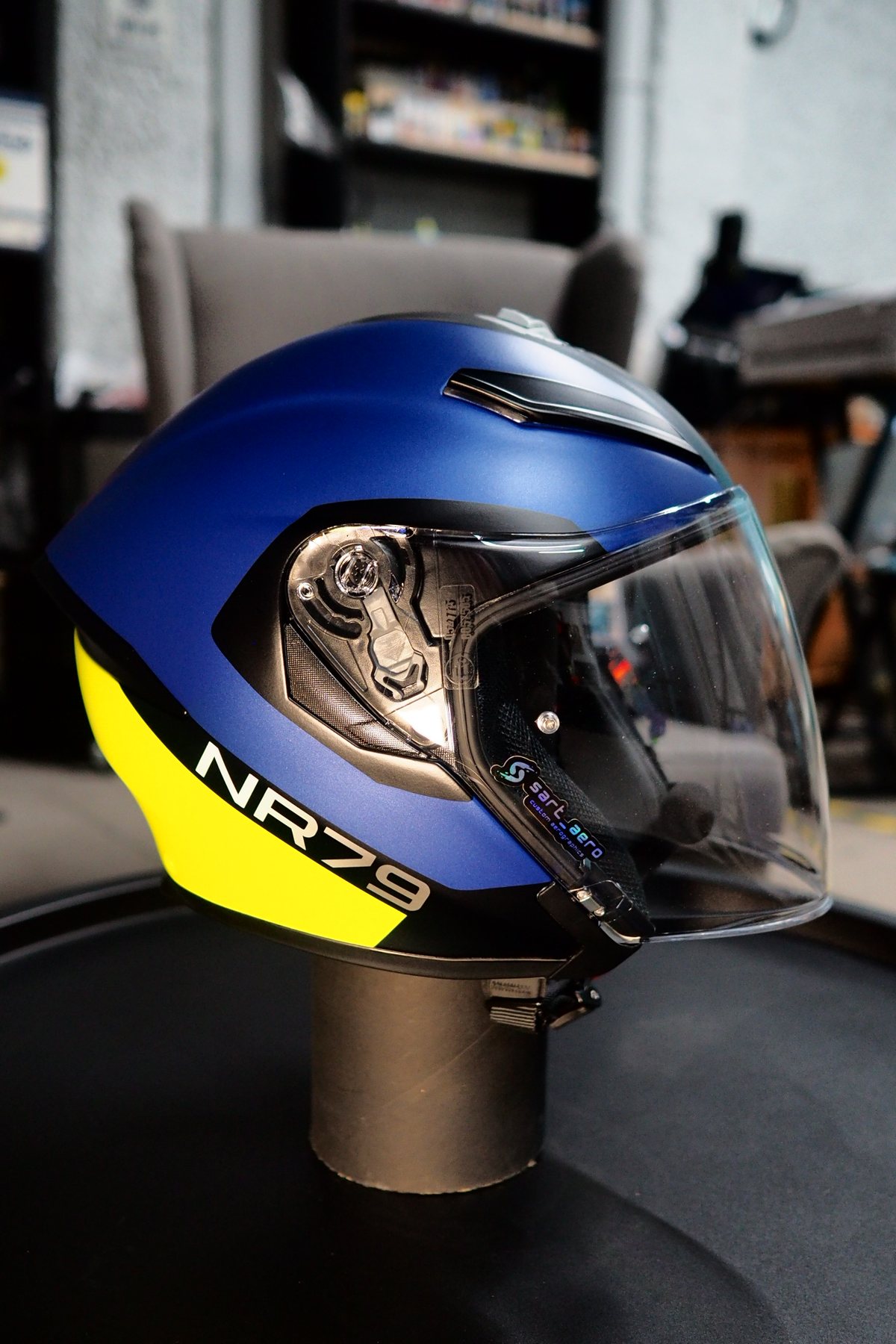Full side view of the BMW CE 04 scooter with the helmet in place