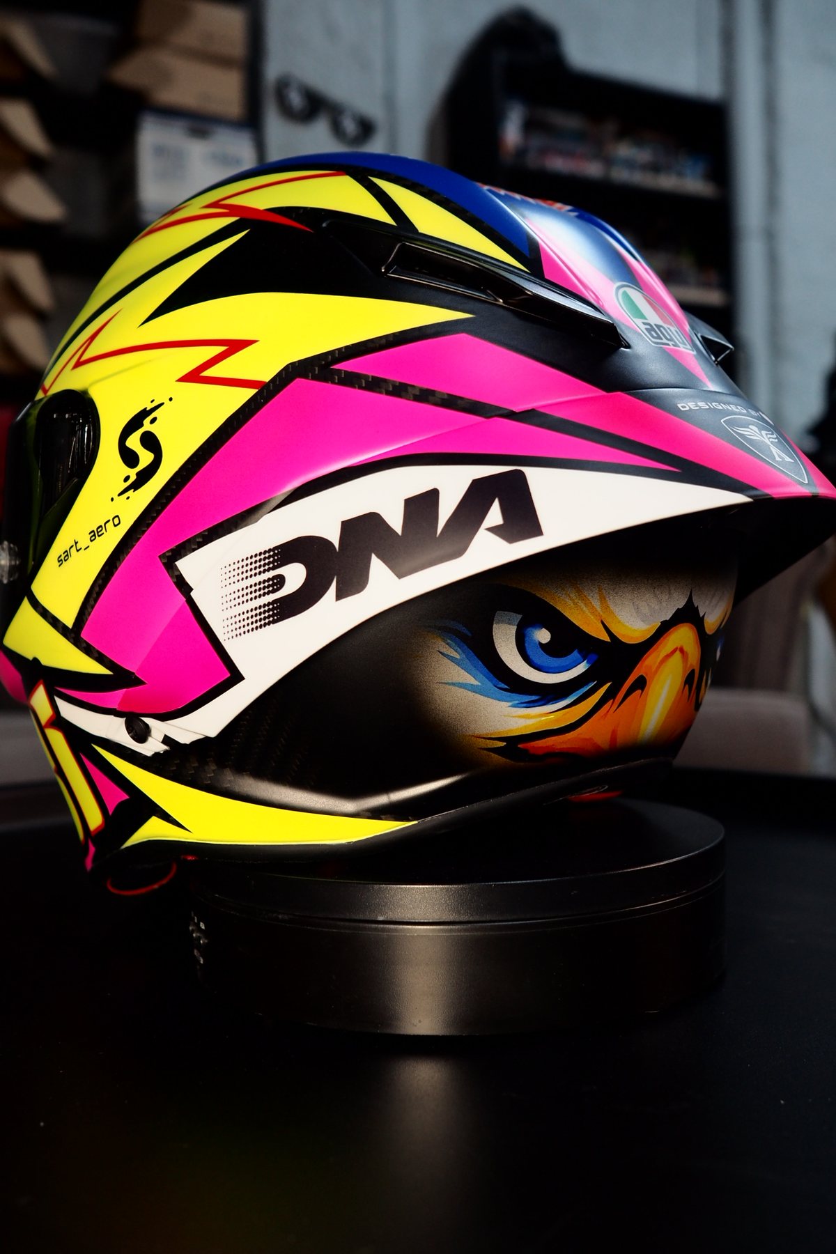 Rear three-quarter view showing the DNA sponsor mark and the lightning shapes