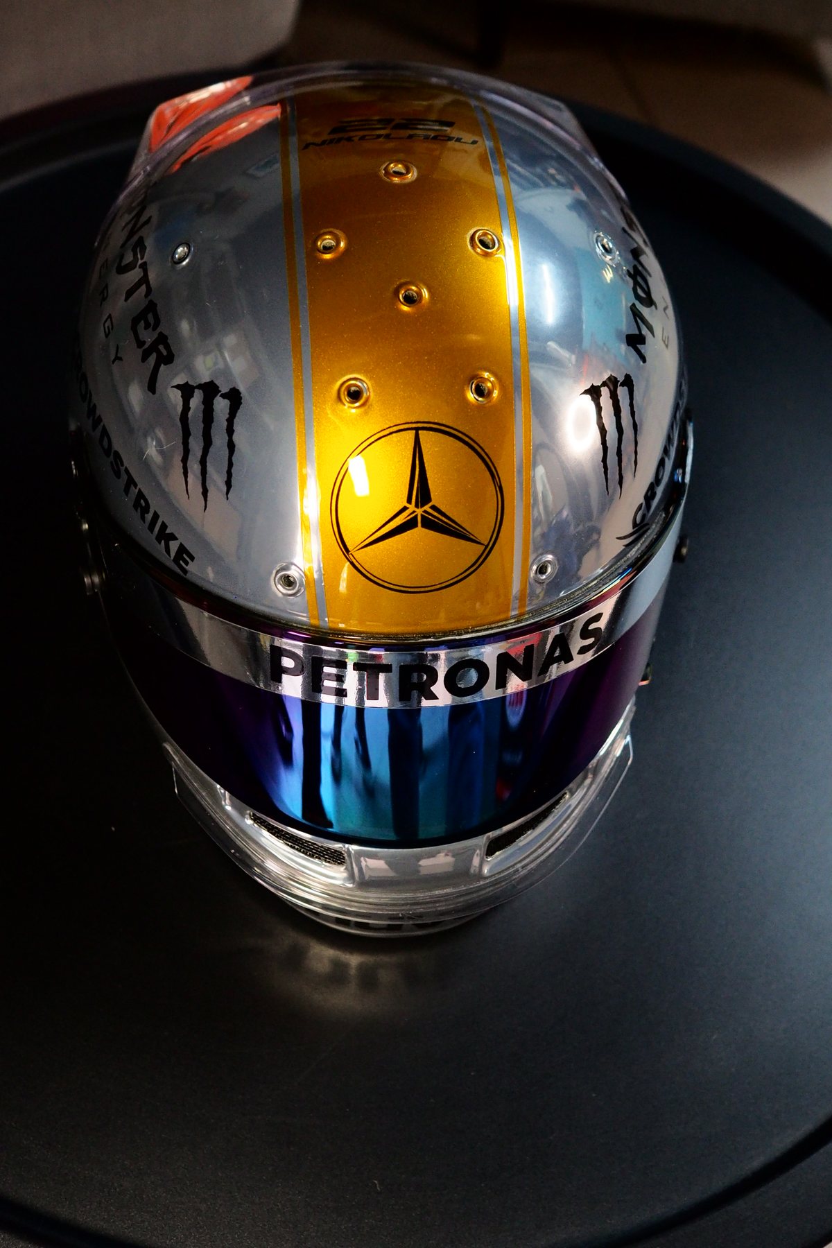 Three-quarter view showing the dark iridescent visor catching the light
