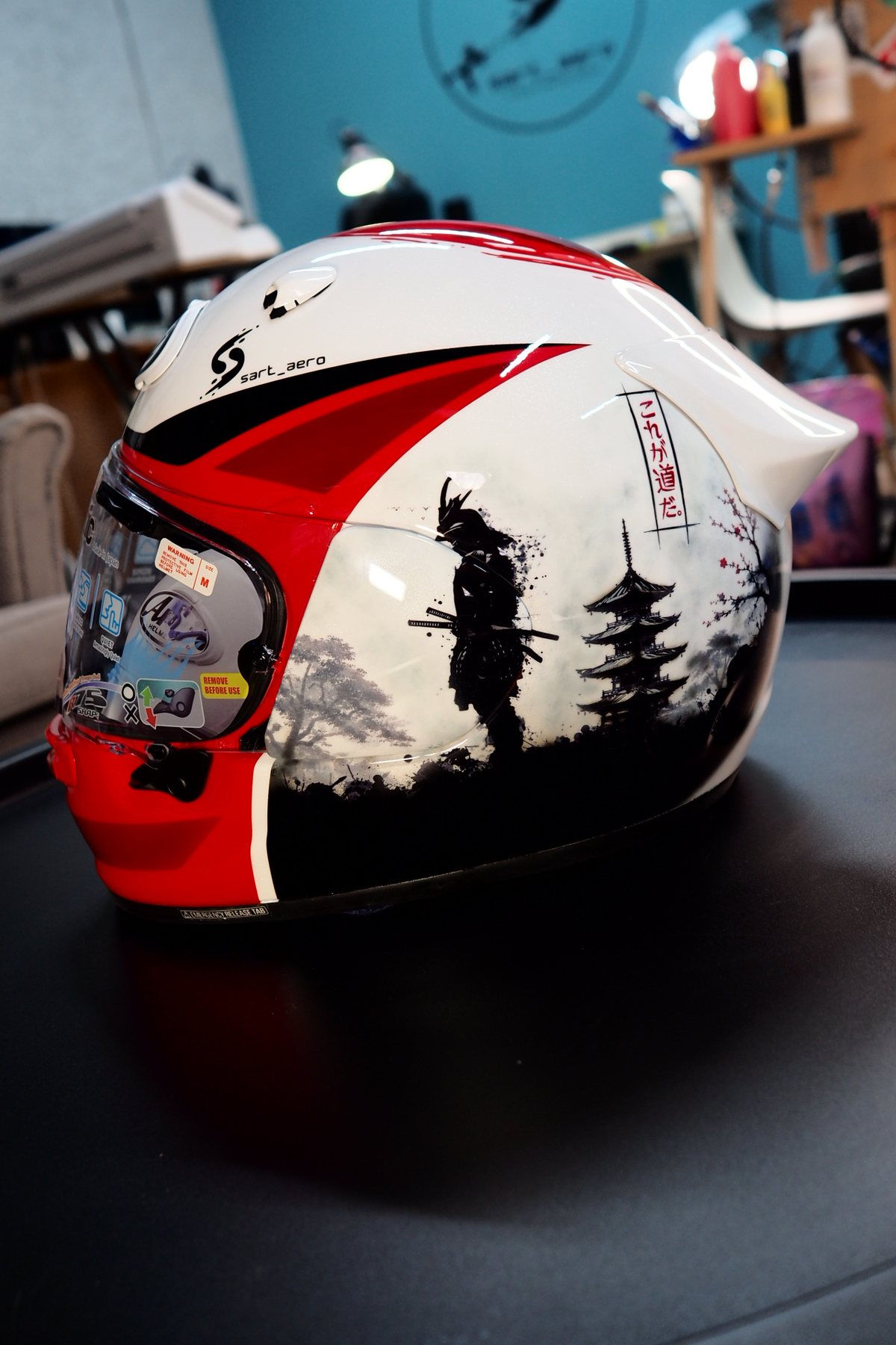 Side view of the helmet showing the samurai figure against the white shell