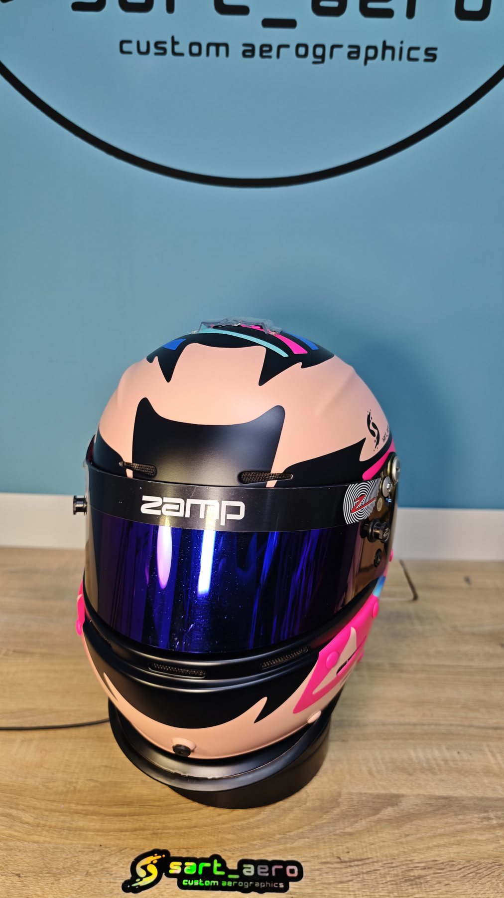 Front view of the nude-pink shell with the black visor aperture and magenta accents
