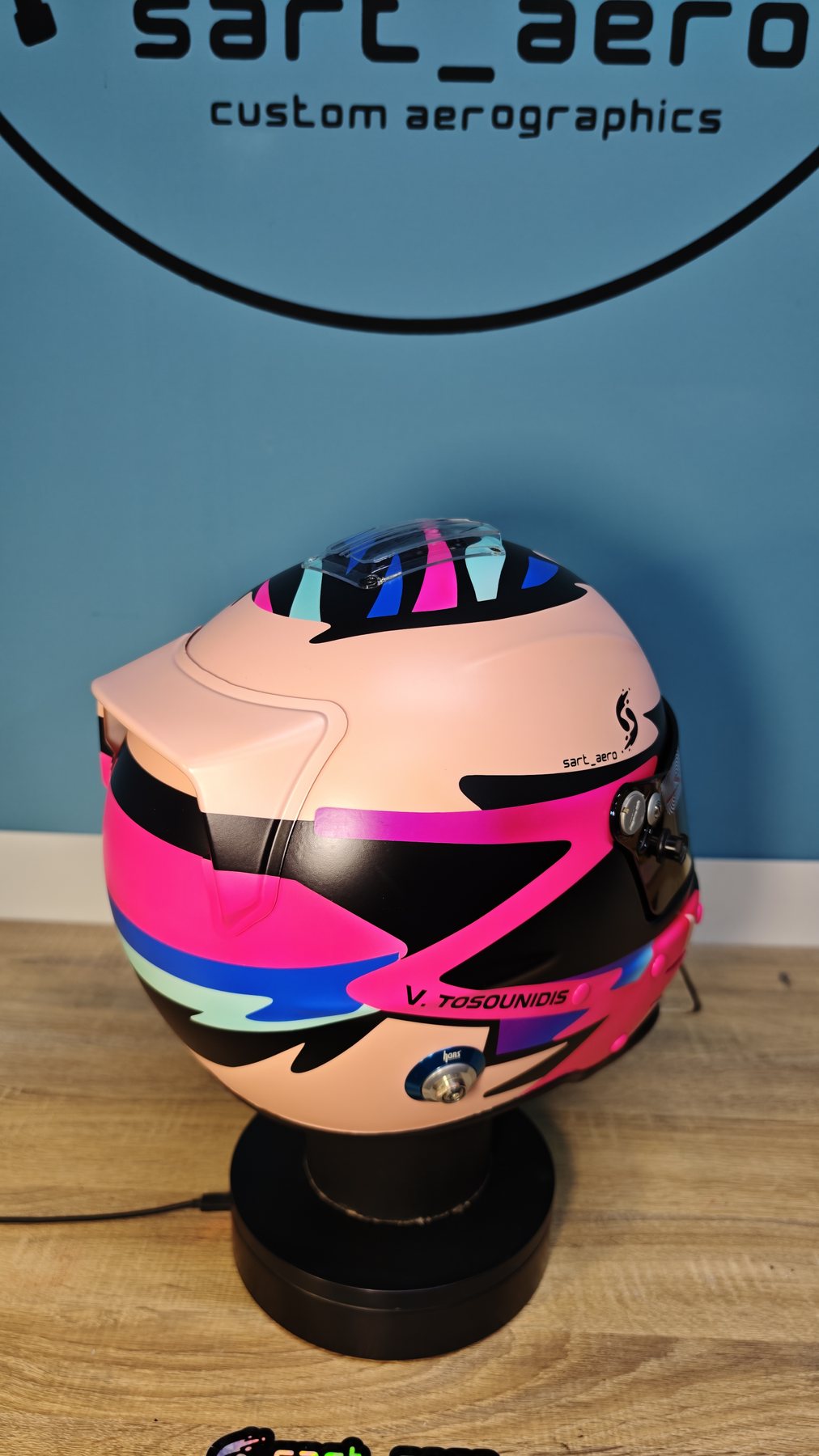 Rear three-quarter showing the cyan and magenta blocks meeting across the back of the shell