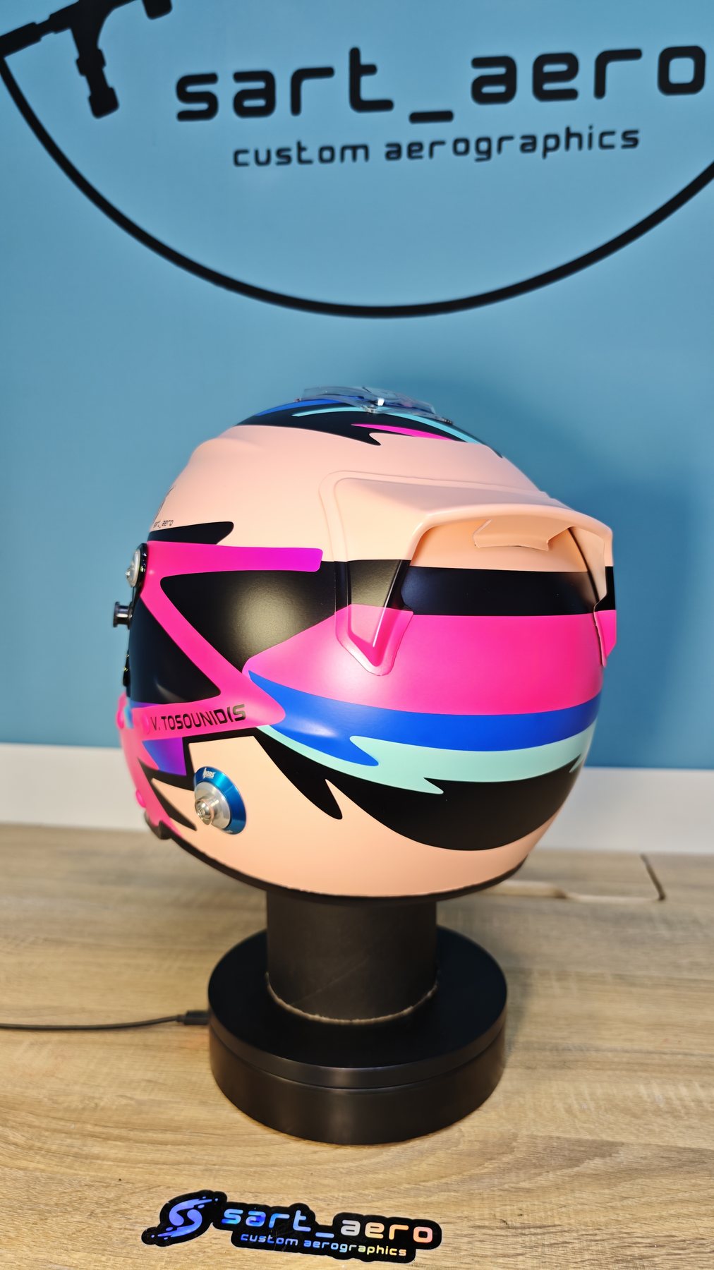 The Kart 1 helmet against the workshop wall, with the driver surname on the side