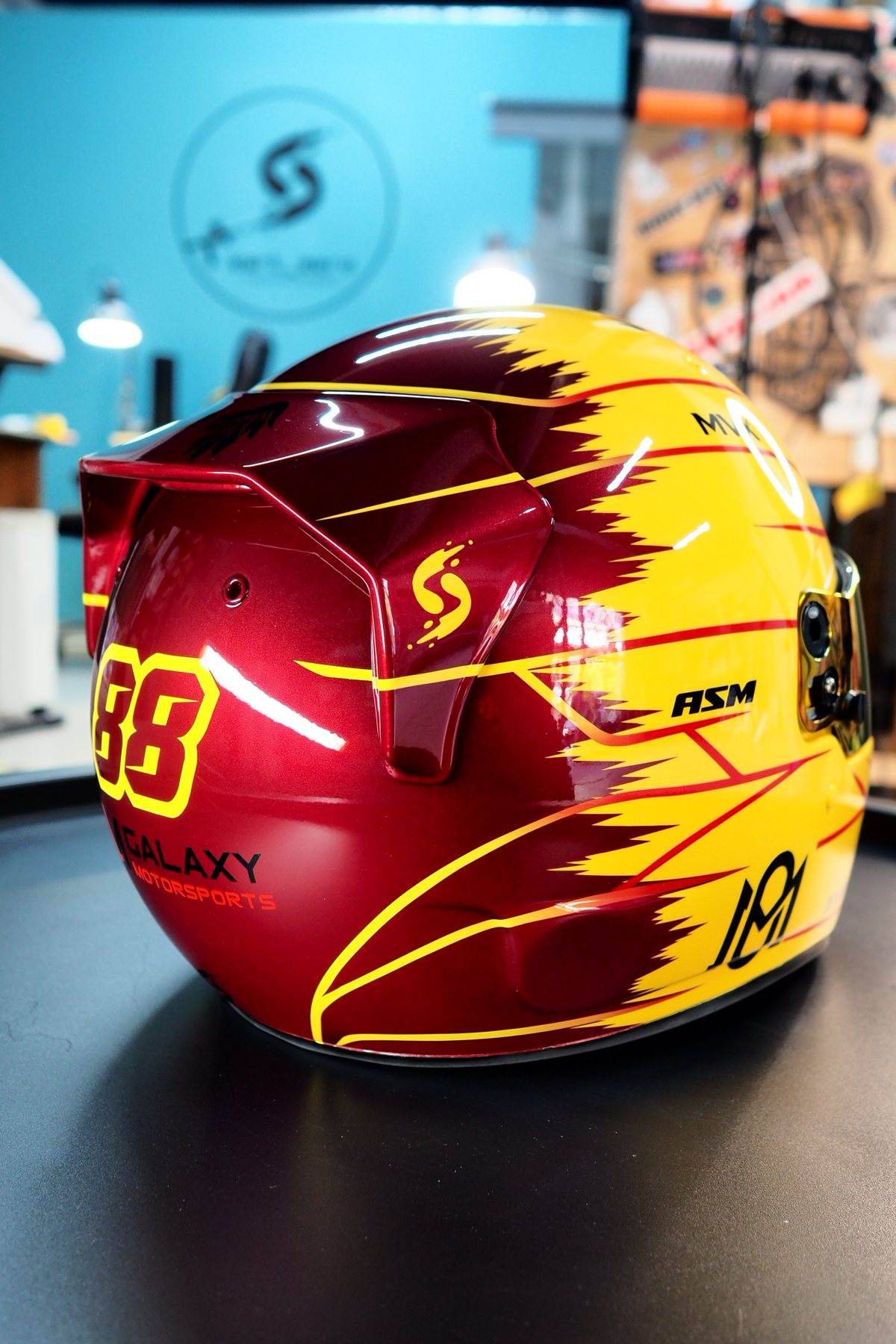 Side view of the burgundy rear section with the red pinstriping