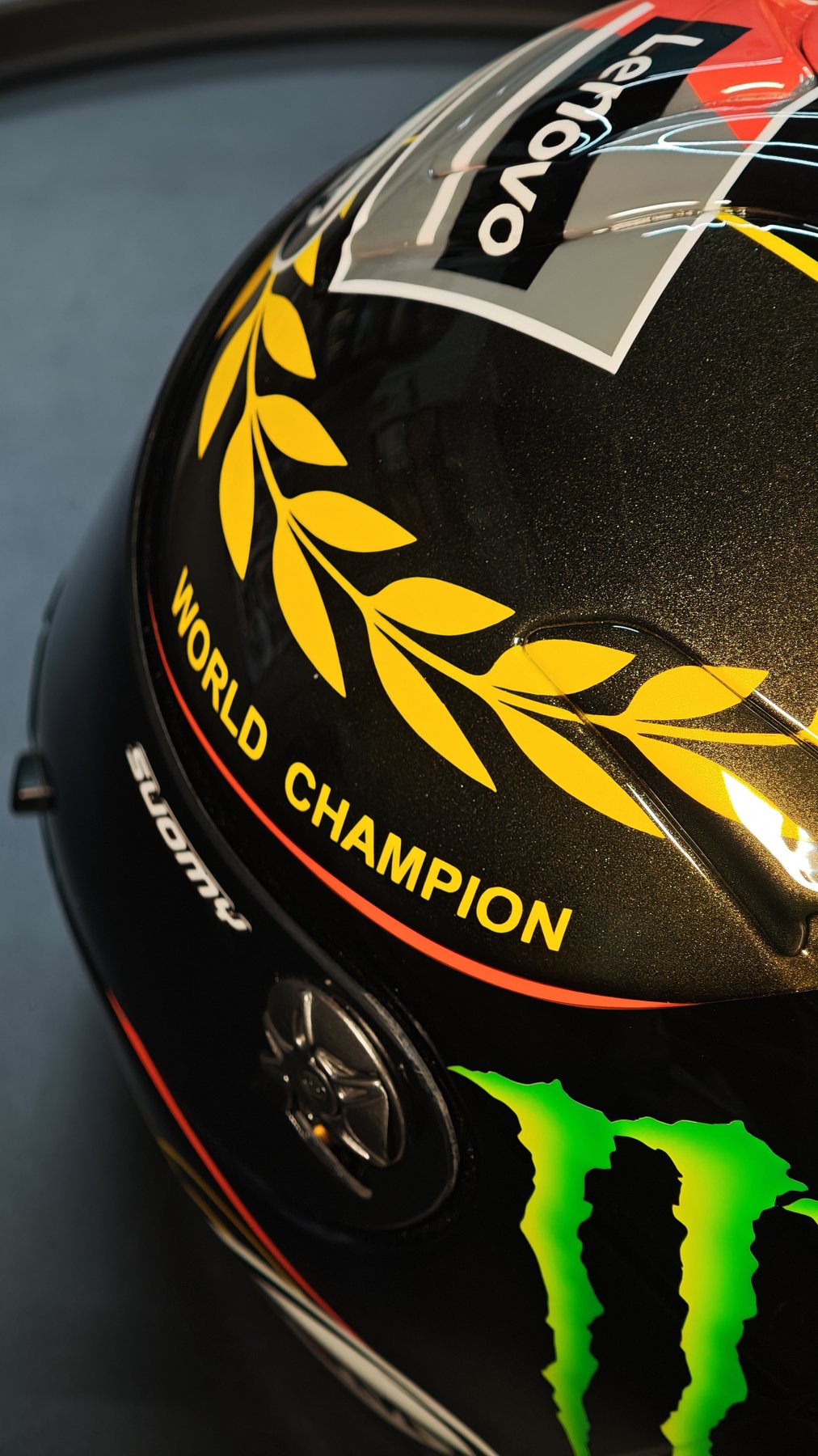 Close-up of the black shell with the gold laurel wreath and WORLD CHAMPION lettering