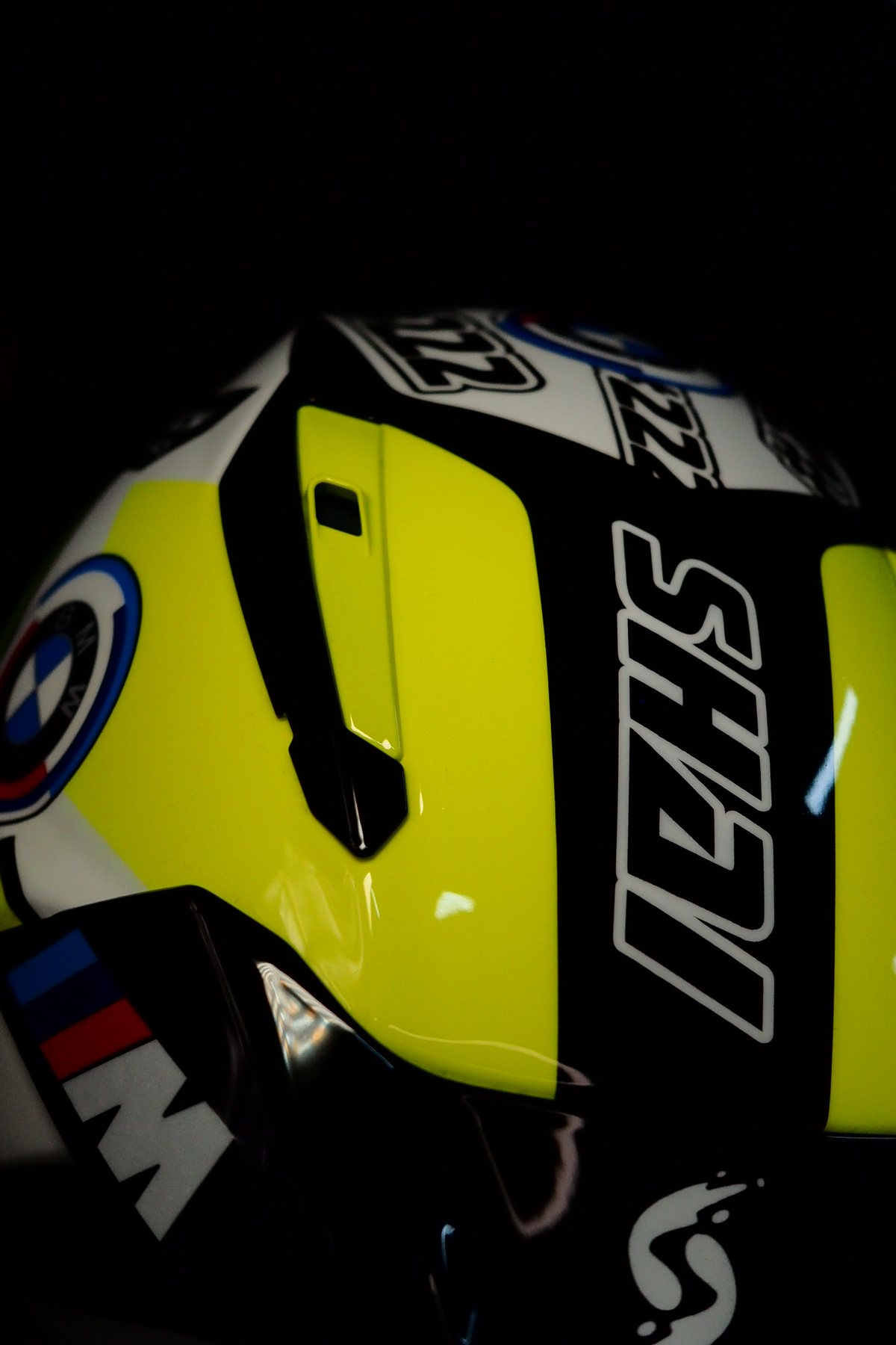 Left side of the Shai 222 helmet with the SHAI name on the rear spoiler and the BMW M tricolour stripes