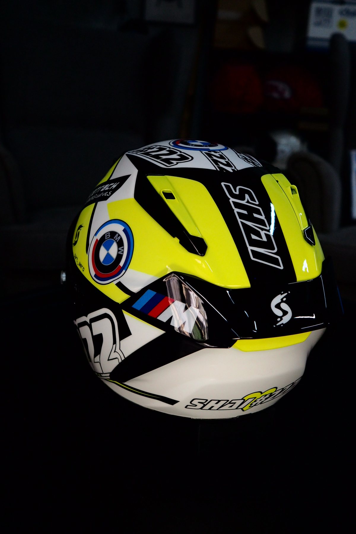 Rear three-quarter of the Shai 222 helmet against a dark background, SHAI lettering and 222 number visible