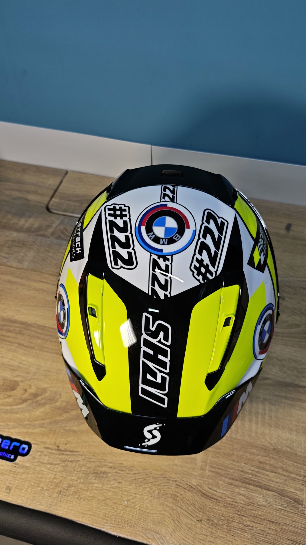 Rear view of the Shai 222 helmet showing the SHAI spoiler lettering, BMW roundel and chequered detail